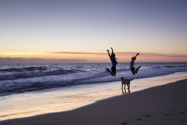 Cheering people at the beach by Aurora Photos