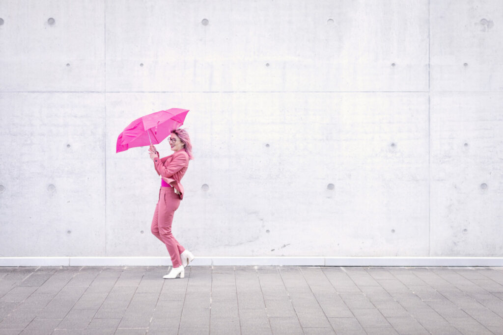 Happy woman pink umbrella gray royalty free stock photo panthermedia